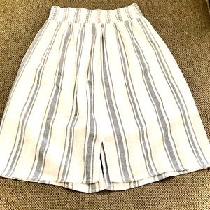 A white skirt with thin light navy blue stripes.